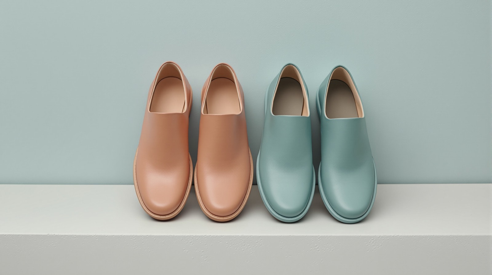Wide-fitting shoes with a roomy toe box arranged on a pale surface