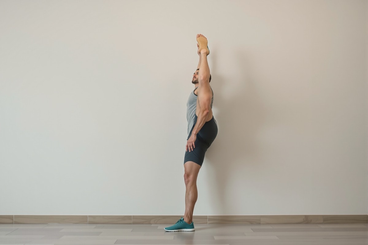 Calf stretch performed against a wall with the back leg extended