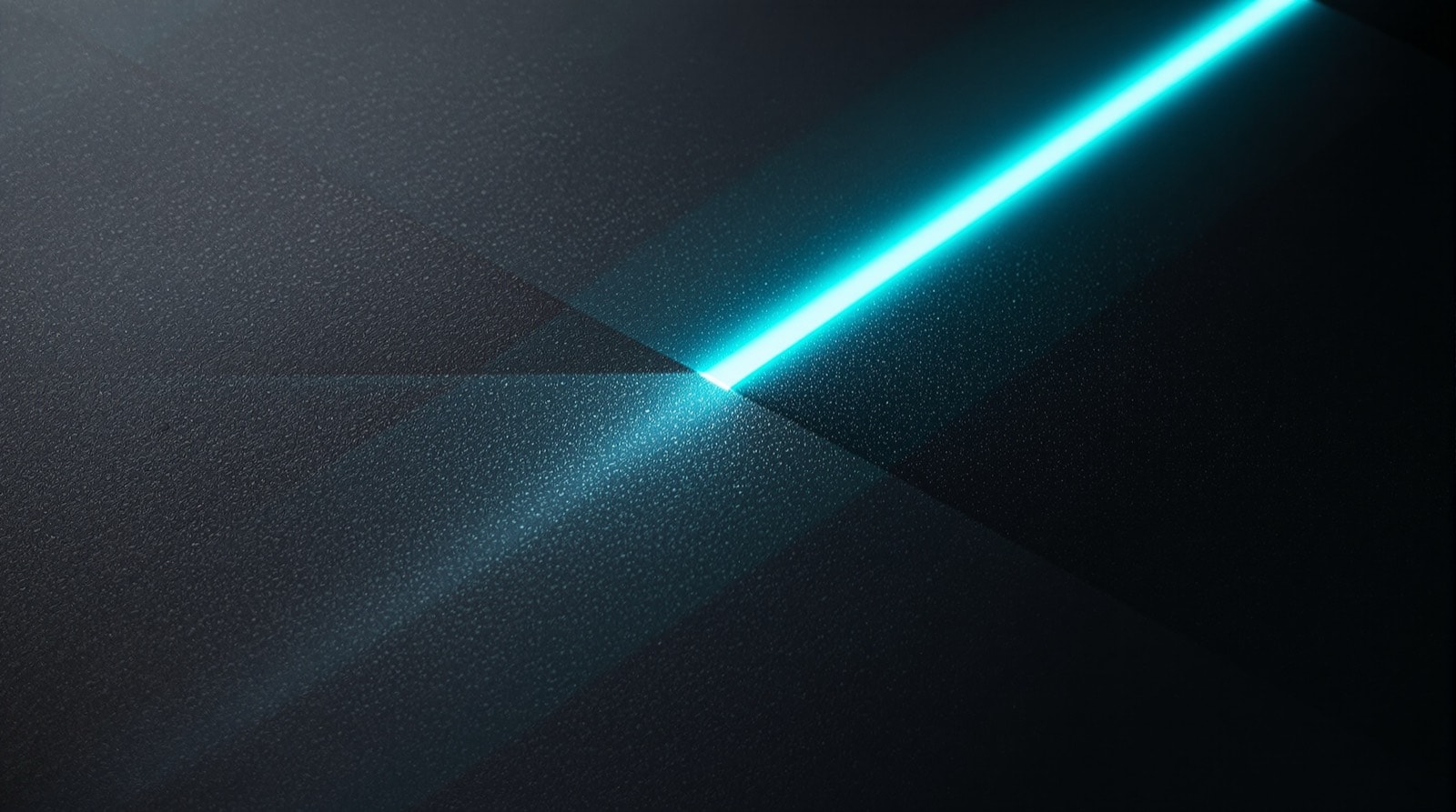 Abstract close-up of a narrow beam of blue-green light crossing a dark surface